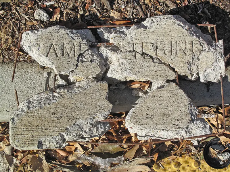 Broken concrete with rusted rebar showing through the cracked surface